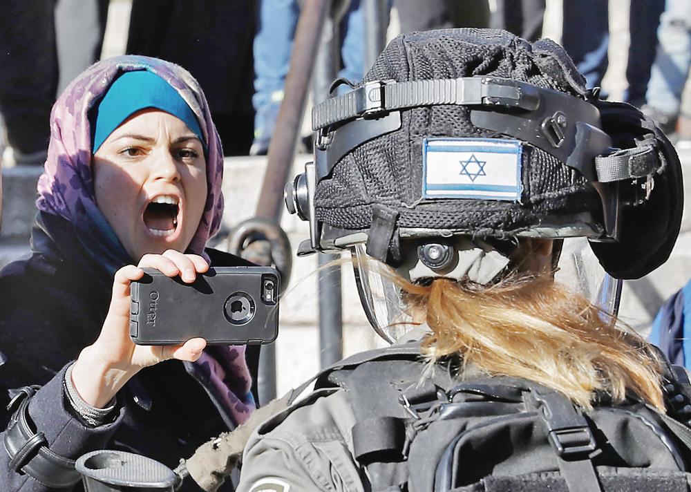 Palestinians scuffle with Israeli forces at Damascus Gate in Jerusalem's Old City on December 8, 2017. Palestinians clashed with Israeli security forces after calls for a 