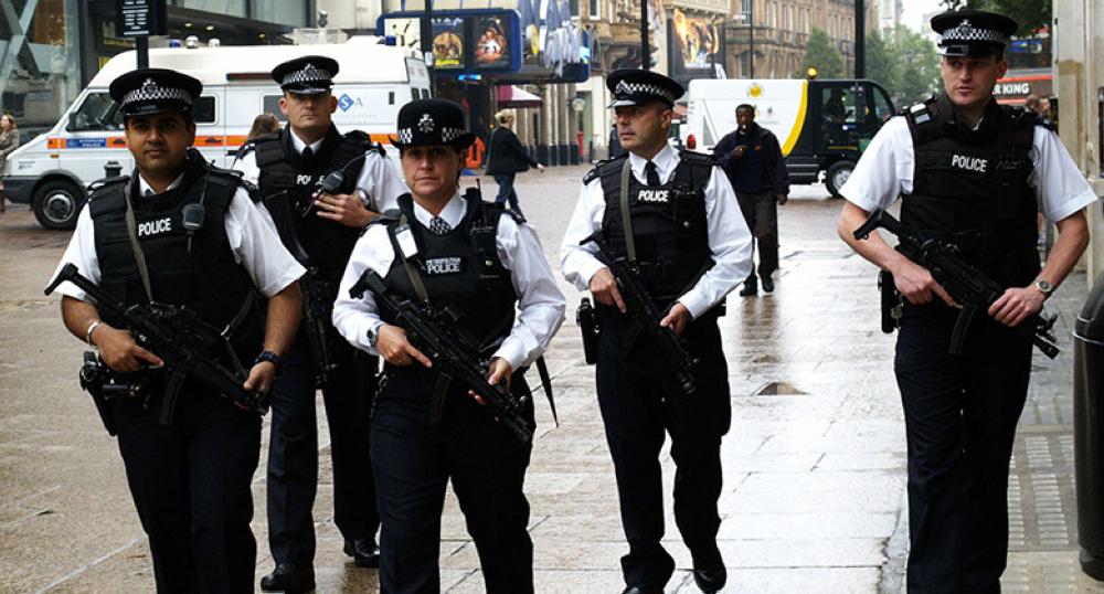 British armed police patrol London's Leicester Square in July 2005, following the suicide bombings on the London transport system. The photo, widely published, was transmitted into the Associated Press World wide network directly from a pda using Phojo, from a nearby wifi point.This copy was sent into the Idruna FTP, via Phojo, at the same compression as the original transmission.photo by max nash 