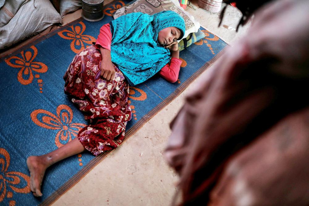 Rohingya refugee Senuwara Begum, 16, rests at her family's makeshift shelter at Balukhali refugee camp near Cox's Bazar, Bangladesh, November 29, 2017. Senuwara Begum lost her right leg after she got shot in the thigh, above the knee, when her village Shahab Bazar, in Maungdaw district, Myanmar, was attacked and burned to the ground by the Myanmar military at the end of August, her father, Sayedul Rahaman, says. Rahaman, a 60-year-old farmer, carried her on his back for six days to cross the Myanmar-Bangladesh border. 