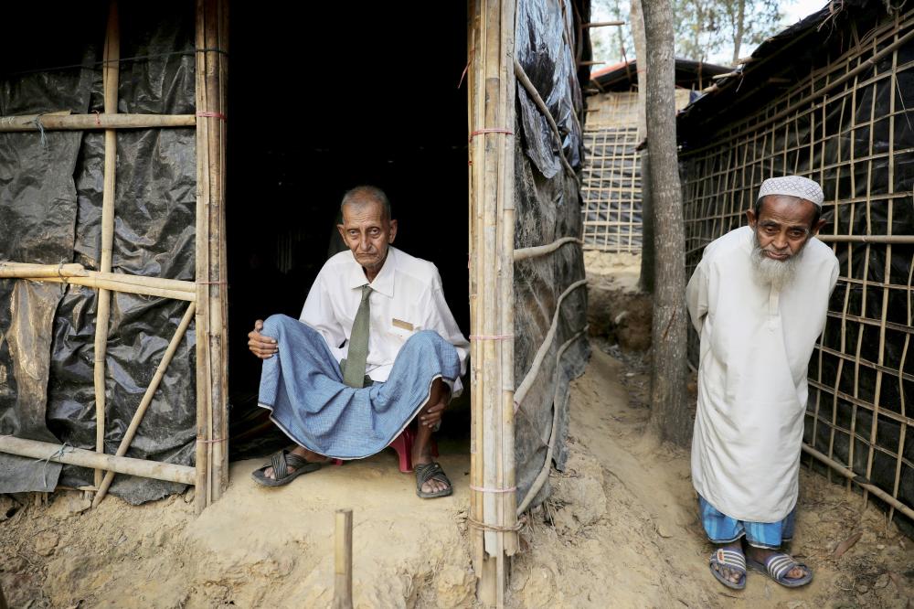 Rohingya refugee Omar Khan (L), who says he is a former general of Myanmar army, poses for a picture as he sits at his temporary shelter at the Kutupalong refugee camp near Cox's Bazar, Bangladesh December 19, 2017. REUTERS/Marko Djurica     TPX IMAGES OF THE DAY