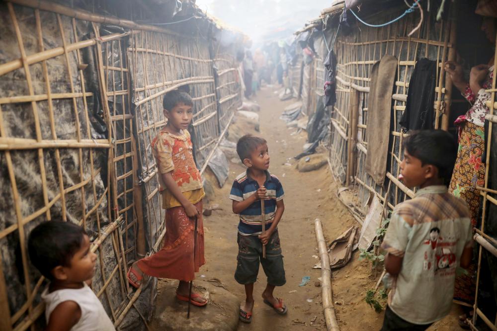 Rohingya children refugees stand in front of their temporary shelters at the Kutupalong refugee camp near Cox's Bazar, Bangladesh December 19, 2017. REUTERS/Marko Djurica