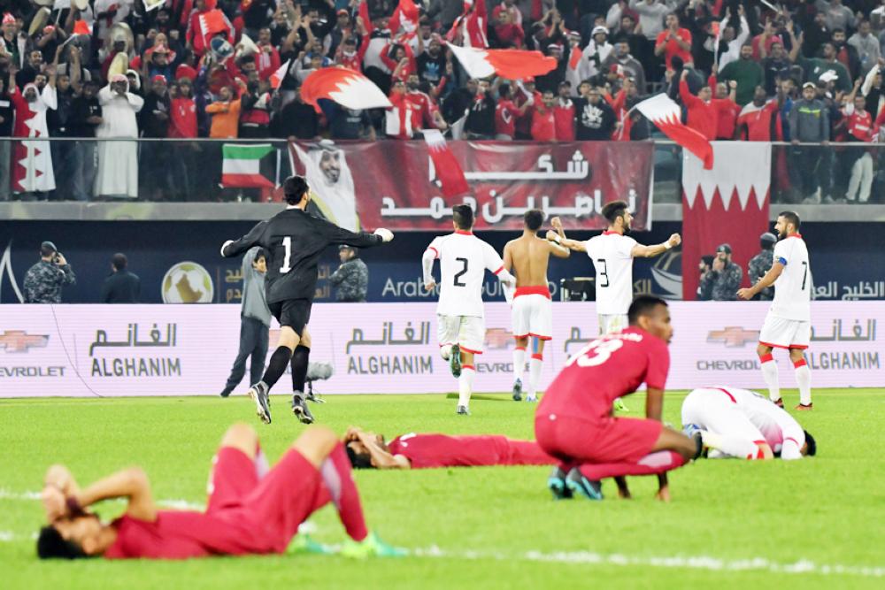 Bahrain's players run in celebration after drawing with Qatar during the 2017 Gulf Cup of Nations football match at the Sheikh Jaber al-Ahmad Stadium in Kuwait City on December 29, 2017.   / AFP / GIUSEPPE CACACE
