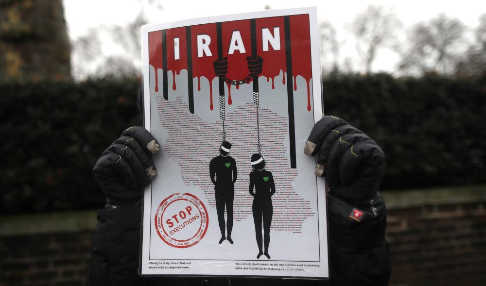 Opponents of Iranian President Hassan Rouhani hold a protest outside the Iranian embassy in west London, Britain, January 2, 2018. REUTERS/Simon Dawson