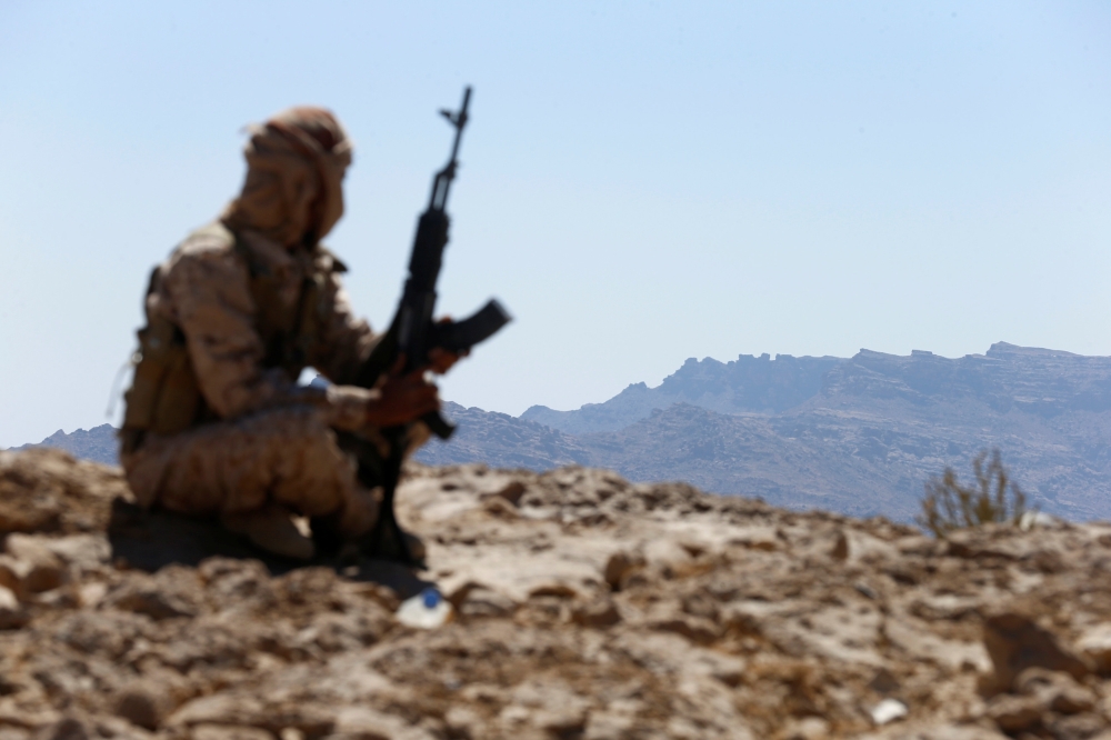 A Yemeni soldier sits on a mountain on the frontline of fighting with Houthis in Nihem area near Sanaa, Yemen January 27, 2018. REUTERS/Faisal Al Nasser