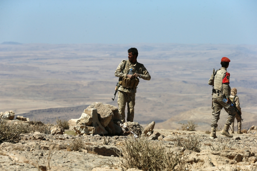 Yemeni soldiers walk on a mountain on the frontline of fighting with Houthis in Nihem area near Sanaa, Yemen January 27, 2018. REUTERS/Faisal Al Nasser