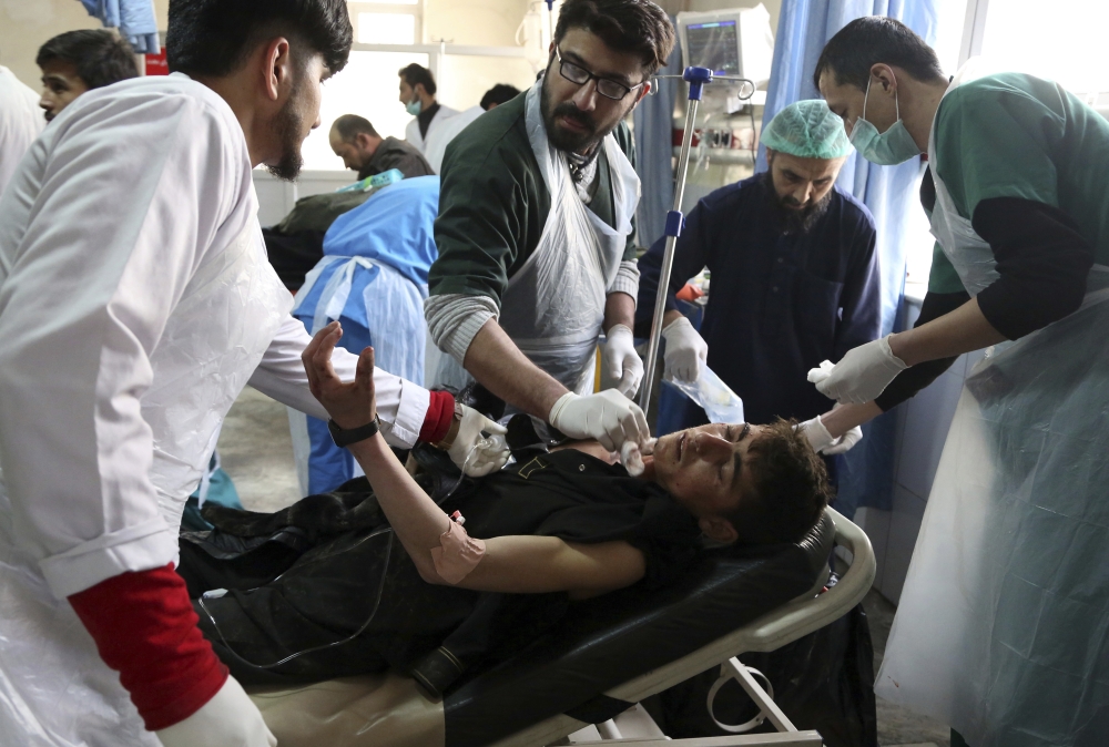 Afghan Injured men receives a treatment at a hospital after a suicide attack in Kabul, Afghanistan, Saturday Jan. 27, 2018. Authorities say suicide car bomber killed dozens of people and wounded over 100 in an attack claimed by the Taliban in the Afghan capital Kabul, authorities said. (AP Photo/ Rahmat Gul)