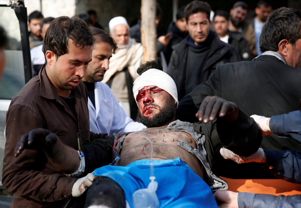 ATTENTION EDITORS - VISUAL COVERAGE OF SCENES OF INJURY An injured man receives medical assistance after a blast in Kabul, Afghanistan January 27, 2018. REUTERS/Mohammad Ismail TEMPLATE OUT     TPX IMAGES OF THE DAY