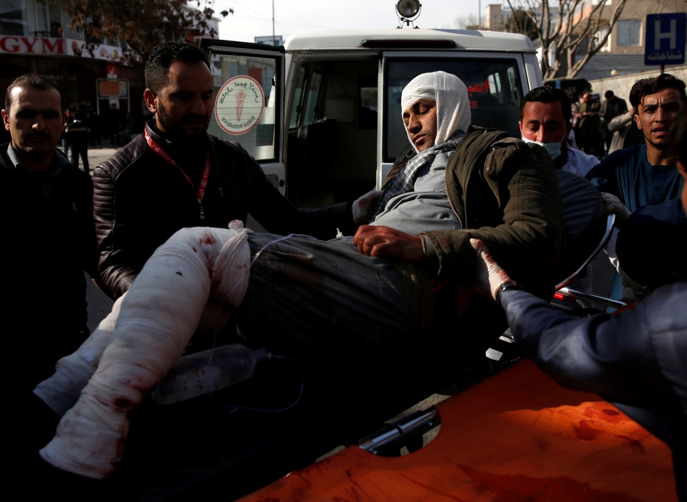 ATTENTION EDITORS - VISUAL COVERAGE OF SCENES OF INJURY OR DEATH An injured man is carried to the hospital after a blast in Kabul, Afghanistan January 27, 2018. REUTERS/Mohammad Ismail