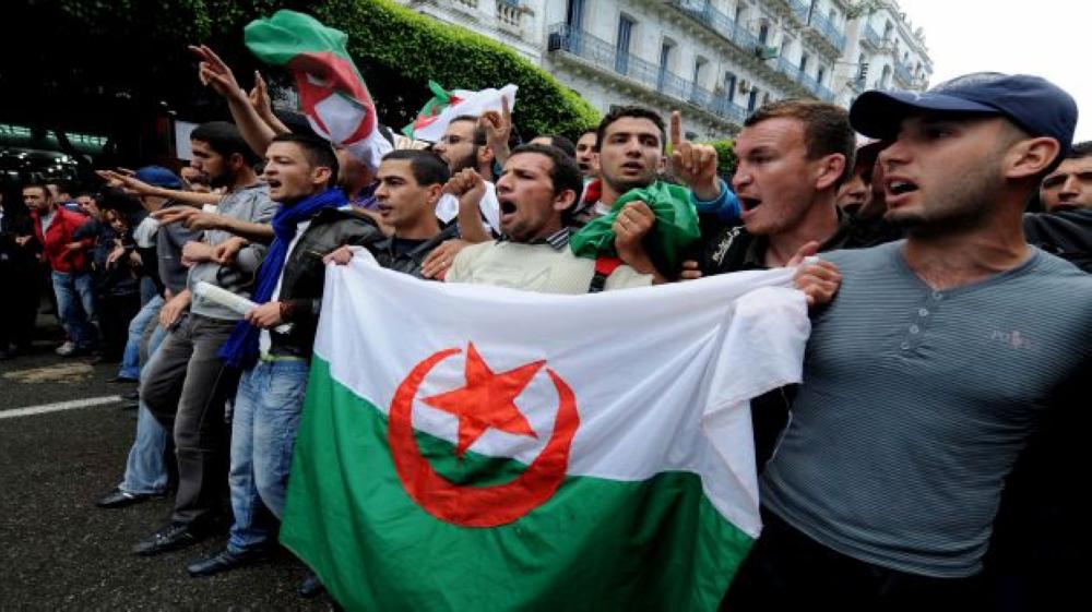 Students hold an Algerian flag at a protest during which clashes erupted between security forces and students demanding political change, leaving at least nine people injured, including three policemen, in Algiers, on May 2, 2011. Demonstrations are currently banned in the north African country, but youths have turned out several times in recent months to confront police equipped with riot shields, helmets, bullet-proof vests and batons. AFP PHOTO / FAROUK BATICHE (Photo credit should read FAROUK BATICHE/AFP/Getty Images)