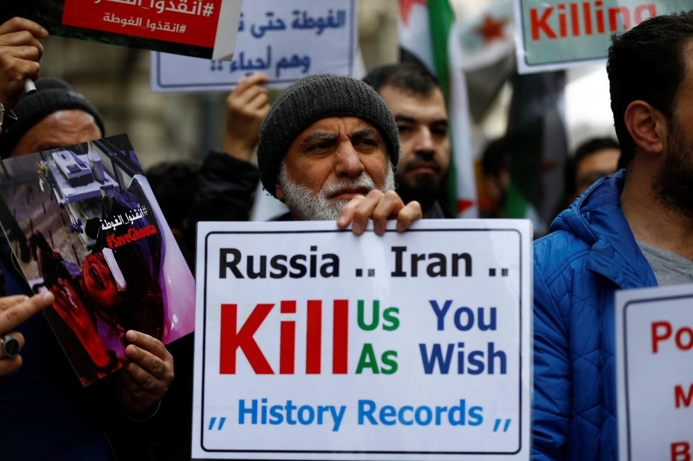 Syrians living in Istanbul gather in front of the Russian Consulate during a protest in Istanbul, Turkey February 22, 2018. REUTERS/Osman Orsal