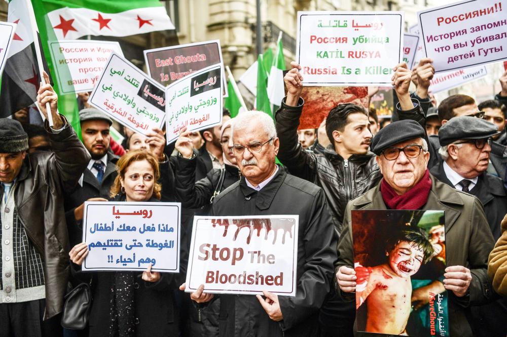 Syrian opposition politician George Sabra (C) takes part in a protest in front of Russian Consulate in Istanbul on February 22, 2018 during a protest against the airstrikes and shelling by the Syrian government forces in Ghouta. The Syrian regime rained rockets and bombs on Eastern Ghouta on February 22, killing another 19 civilians as international pressure mounted to stop the carnage in the rebel-held enclave. / AFP / OZAN KOSE
