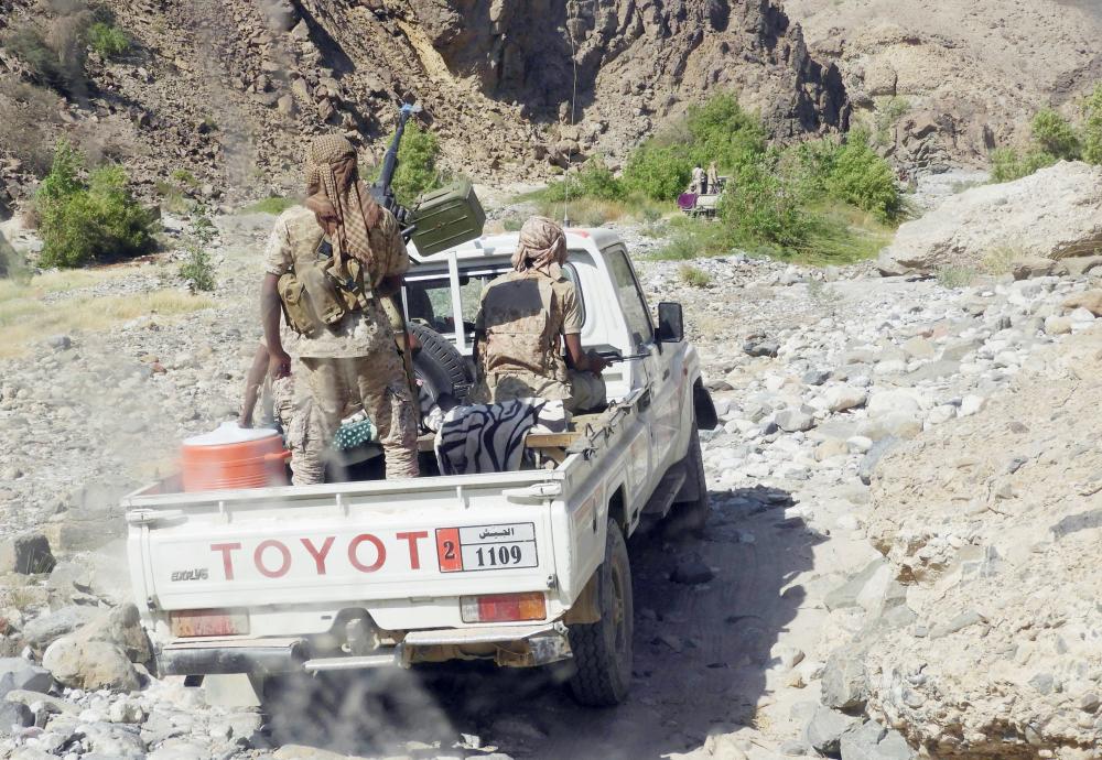 Yemeni fighters loyal to the government backed by the Saudi-led coalition fighting in the country ride in the back of a pickup truck with mounted heavy machine gun while closing in on a suspected location of an Al-Qaeda in the Arabian Peninsula (AQAP) leader during their the offensive in the Mesini Valley in the vast province of Hadramawt on February 21, 2018. Yemeni special forces trained by the United Arab Emirates -- a key member of a Saudi-led alliance fighting alongside Yemen's government forces -- had in the previous week launched the offensive, codenamed 