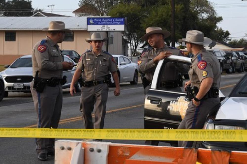 State troopers guard the entrance to the First Baptist Church (back) after a mass shooting that killed 26 people in Sutherland Springs, Texas on November 6, 2017.
A gunman wearing all black armed with an assault rifle opened fire on a small-town Texas church during Sunday morning services, killing 26 people and wounding 20 more in the last mass shooting to shock the United States. / AFP PHOTO / Mark RALSTON