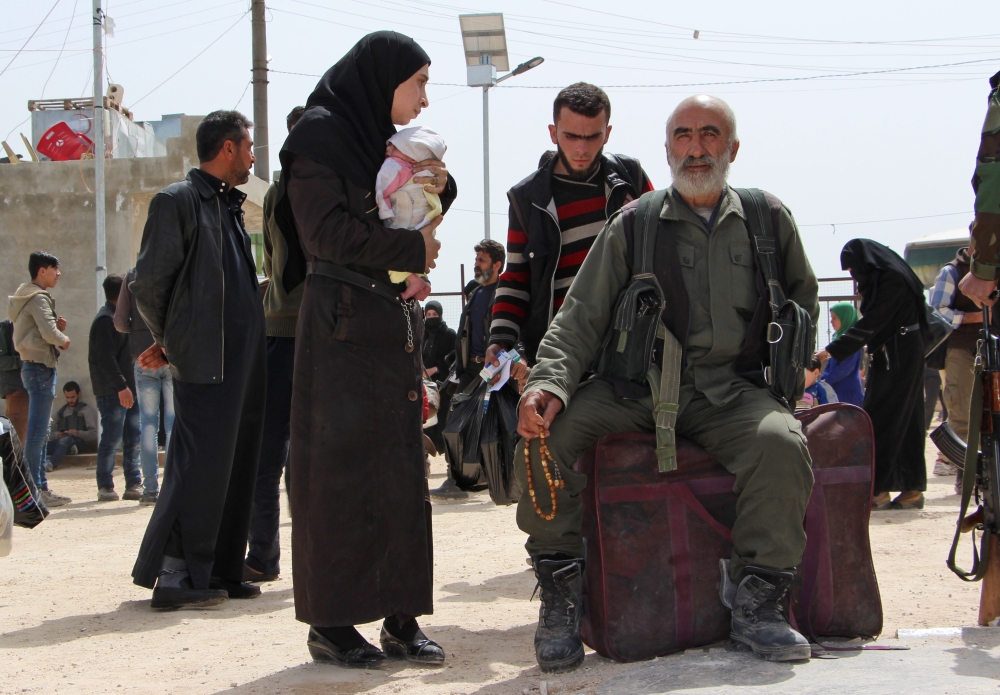 Syrians who were evacuated from the rebel-held town of Harasta in Eastern Ghouta arrive at a camp for displaced people in Maaret al-Ikhwan, in Syria's rebel-held Idlib province on March 23, 2018. Hundreds of fighters evacuated by the Syrian regime from their Eastern Ghouta bastion arrived in Idlib province, the Britain-based Syrian Observatory for Human Rights said. / AFP / Ibrahim YASOUF
