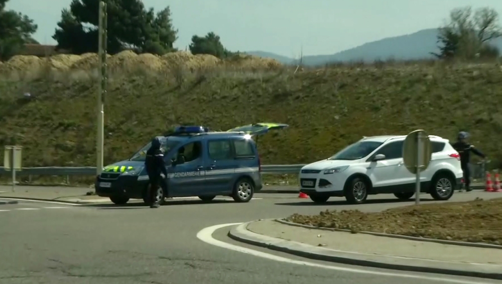 In this image taken from BFM TV shows a police vehicle parked on a crossroad in Trebes, southern France, near the scene of an incident, Friday March 23, 2018. French counterterrorism prosecutors are taking charge of the investigation into the shooting of a police officer in southern France that has led to an apparent hostage-taking at a supermarket. (BFM TV via AP)