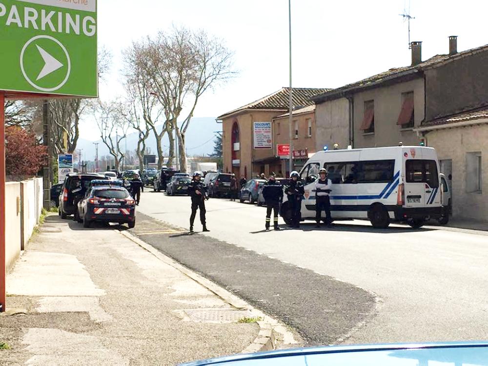 Police are seen at the scene of a hostage situation in a supermarket in Trebes, Aude, France March 23, 2018 in this picture obtained from a social media video. LA VIE A TREBES/via REUTERS ATTENTION EDITORS - THIS IMAGE WAS PROVIDED BY A THIRD PARTY. NO RESALES. NO ARCHIVES. MANDATORY CREDIT.