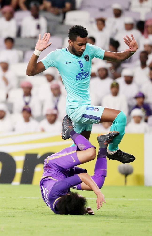 Al-Ain's midfielder and captain Omar Abdulrahman (R) is fouled by al-Hilal's defender 	Ali al-Bulaihi during the AFC Champions League football match between UAE's al-Ain and Saudi's al-Hilal at the Hazza bin Zayed Stadium in Al-Ain, on April 2, 2018. / AFP / KARIM SAHIB
