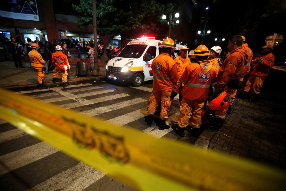 Rescue personnel and an ambulance are seen behind yellow tape outside the Andino shopping center after an explosive device detonated in a restroom, in Bogota, Colombia June 17, 2017. REUTERS/Jaime Saldarriaga