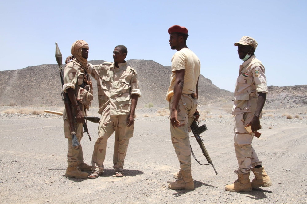 (FILES) In this file photo taken on April 12, 2017 Sudanese soldiers patrol outside the west of the Yemeni coastal port town of Mokha. Although Sudan has vowed to remain in the Saudi-led coalition fighting rebels in Yemen, calls for Khartoum to withdraw its troops from the war-torn country have increased after a deadly ambush.
 / AFP / SALEH AL-OBEIDI
