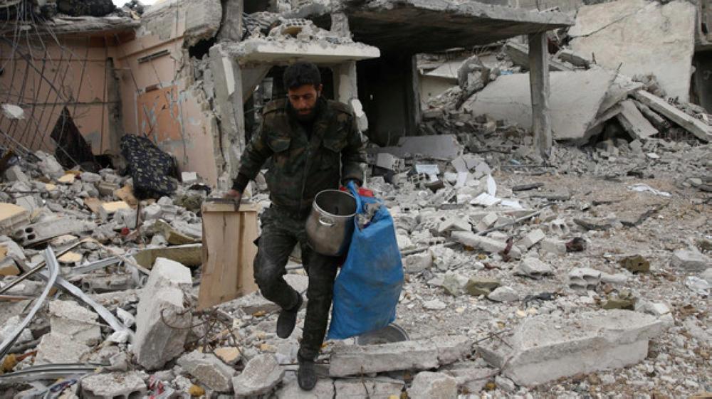 A man walks on rubble of damaged buildings in the besieged town of Douma, Eastern Ghouta, in Damascus, Syria March 30, 2018. REUTERS/Bassam Khabieh