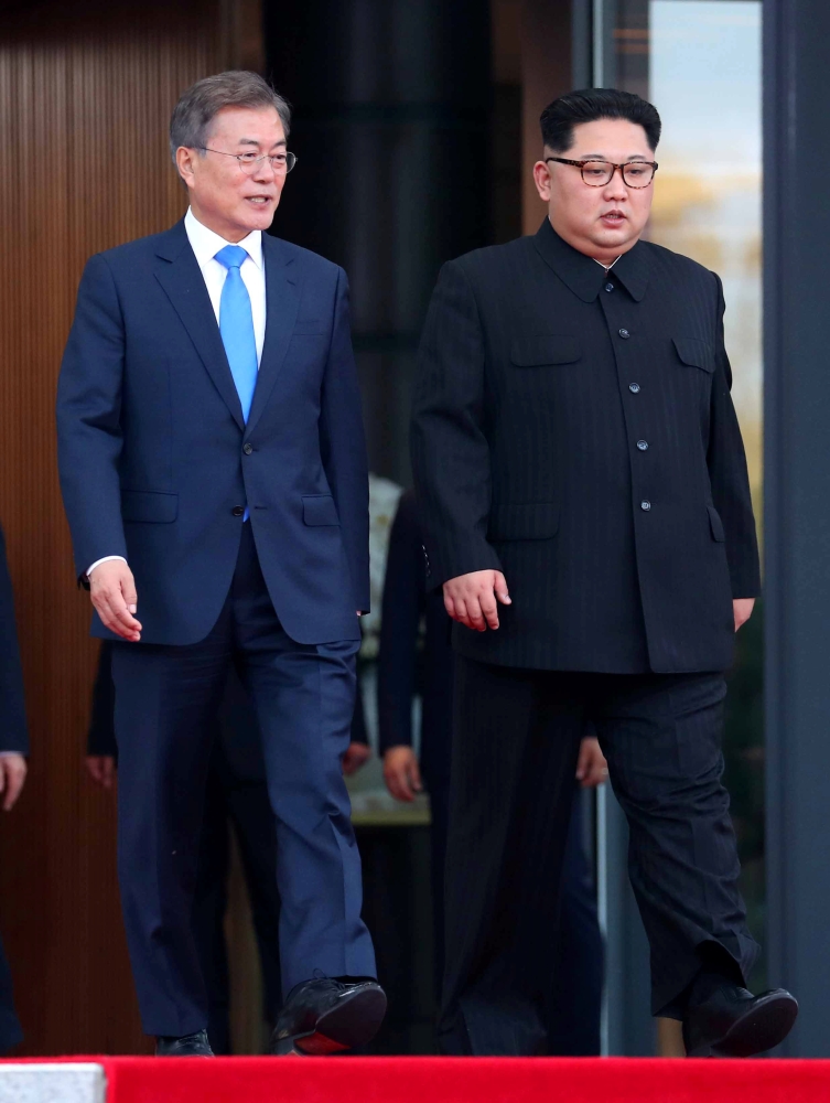 South Korean President Moon Jae-in and North Korean leader Kim Jong Un walk together at the truce village of Panmunjom inside the demilitarized zone separating the two Koreas, South Korea, April 27, 2018. Korea Summit Press Pool/Pool via Reuters