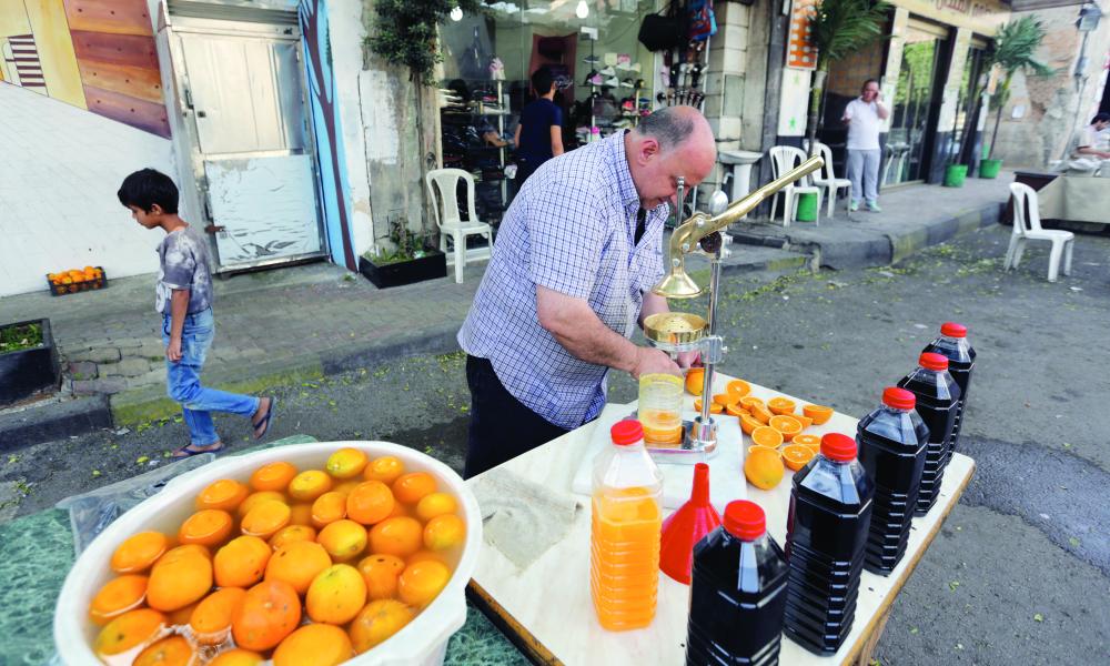 epa06753108 A Syrian makes juice at al-Midan neighborhood in Damascus, Syria, 20 May 2018. Muslims around the world celebrate the holy month of Ramadan by praying during the night time and abstaining from eating, drinking, and sexual acts during the period between sunrise and sunset. Ramadan is the ninth month in the Islamic calendar and it is believed that the revelation of the first verse in Koran was during its last 10 nights. EPA/YOUSSEF BADAWI