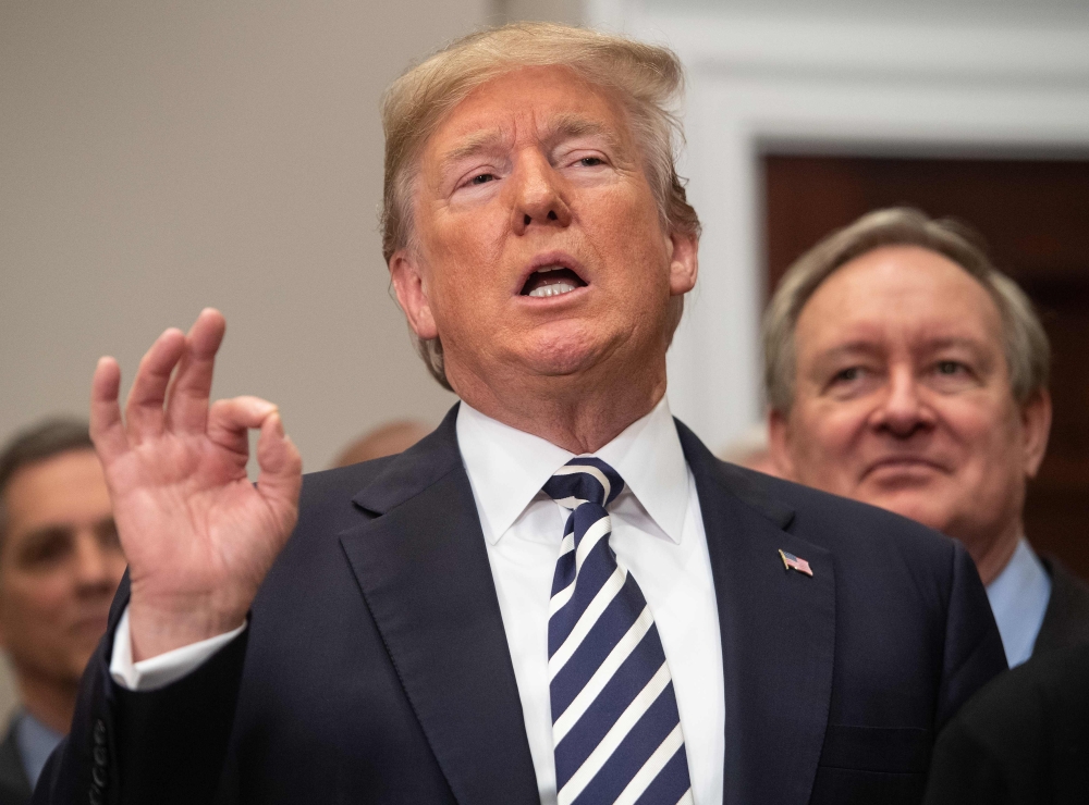 TOPSHOT - US President Donald Trump speaks after signing the Economic Growth, Regulatory Relief, and Consumer Protection Act in the Roosevelt Room at the White House in Washington, DC, on May 24, 2018. Donald Trump's decision to cancel a June 12 summit with North Korea's Kim Jong Un is the latest dramatic twist in relations between two leaders who traded insults before laying the groundwork for what would have been a stunning rapprochement. / AFP / NICHOLAS KAMM
