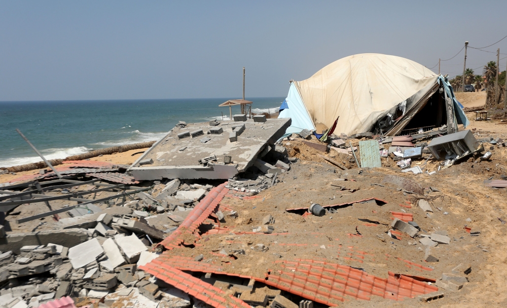 A picture taken on May 30, 2018 shows damage at a site targeted by an Israeli air strike a day before in Khan Younis in the southern Gaza strip. Israel said it targeted some 65 militant sites in the Gaza Strip a day earlier and into the early morning hours and around 100 rockets and mortars fired from Gaza either exploded in Israel or were intercepted by air defences, in the worst military flare-up since a 2014 war.  / AFP / MAHMUD HAMS
