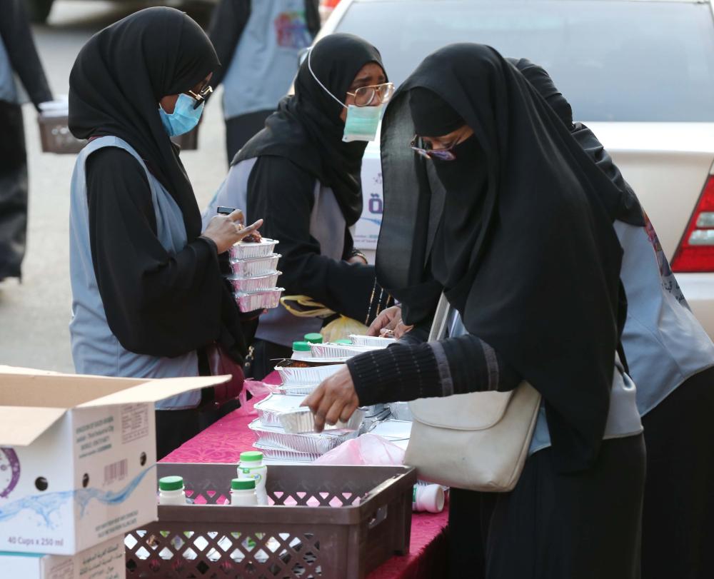 المتطوعات يعددن وجبات إفطار صائم. (تصوير: عمرو سلام)