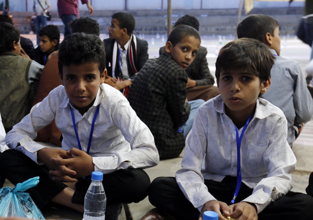 epa06799481 Yemeni orphans wait to eat meal during a banquet as part of a charity program for orphans during the Muslim fasting month of Ramadan in Sana'a, Yemen, 10 June 2018. Muslims around the world celebrate the holy month of Ramadan by praying during the night time and abstaining from eating, drinking, and sexual acts during the period between sunrise and sunset. Ramadan is the ninth month in the Islamic calendar and it is believed that the revelation of the first verse in Koran was during its last 10 nights. EPA/YAHYA ARHAB