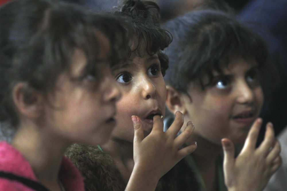 epa06799478 Yemeni orphans eat a meal during a banquet as part of a charity program for orphans during the Muslim fasting month of Ramadan in Sana'a, Yemen, 10 June 2018. Muslims around the world celebrate the holy month of Ramadan by praying during the night time and abstaining from eating, drinking, and sexual acts during the period between sunrise and sunset. Ramadan is the ninth month in the Islamic calendar and it is believed that the revelation of the first verse in Koran was during its last 10 nights. EPA/YAHYA ARHAB