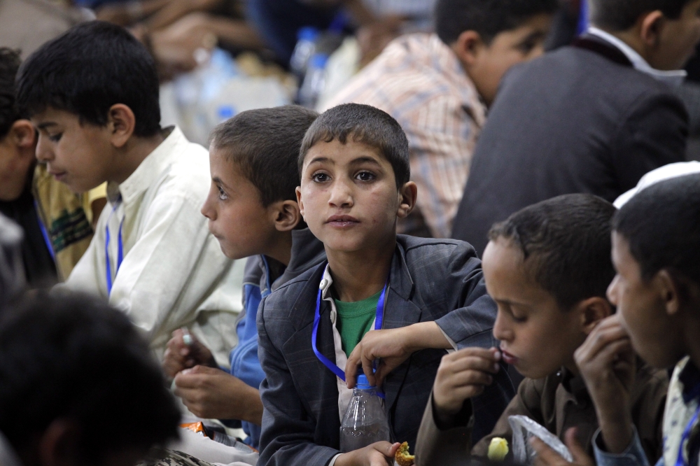 epa06799444 Yemeni orphans eat a meal during a banquet as part of a charity program for orphans during the Muslim fasting month of Ramadan in Sana'a, Yemen, 10 June 2018. Muslims around the world celebrate the holy month of Ramadan by praying during the night time and abstaining from eating, drinking, and sexual acts during the period between sunrise and sunset. Ramadan is the ninth month in the Islamic calendar and it is believed that the revelation of the first verse in Koran was during its last 10 nights. EPA/YAHYA ARHAB