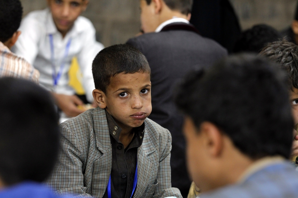 epa06799442 Yemeni orphans eat a meal during a banquet as part of a charity program for orphans during the Muslim fasting month of Ramadan in Sana'a, Yemen, 10 June 2018. Muslims around the world celebrate the holy month of Ramadan by praying during the night time and abstaining from eating, drinking, and sexual acts during the period between sunrise and sunset. Ramadan is the ninth month in the Islamic calendar and it is believed that the revelation of the first verse in Koran was during its last 10 nights. EPA/YAHYA ARHAB