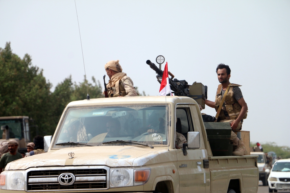 epa06803021 Yemeni forces backed by the Saudi-led coalition gather near the outskirts of the western port city of Hodeidah, Yemen, 12 June 2018. According to reports, the Saudi-led military coalition and Yemeni government forces continue to send reinforcements toward the port city of Hodeidah, preparing to launch an assault on the Houthis-controlled main port of Yemen.  EPA/NAJEEB ALMAHBOOBI