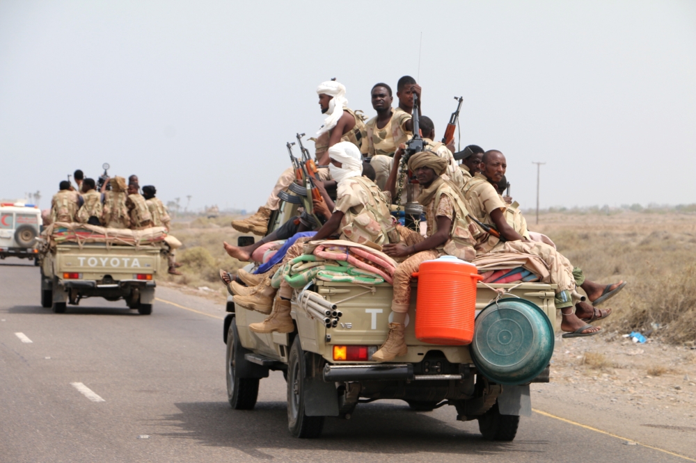 epa06802967 Sudanese forces fighting alongside the Saudi-led coalition in Yemen gather near the outskirts of the western port city of Hodeidah, Yemen, 12 June 2018. According to reports, the Saudi-led military coalition and Yemeni government forces continue to send reinforcements toward the port city of Hodeidah, preparing to launch an assault on the Houthis-controlled main port of Yemen.  EPA/NAJEEB ALMAHBOOBI