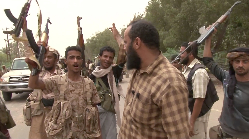 This image grab taken from a video shows Yemeni pro-government forces gathering at the south of Hodeida airport, in Yemen's Hodeida province on June 15, 2018. / AFP / -
