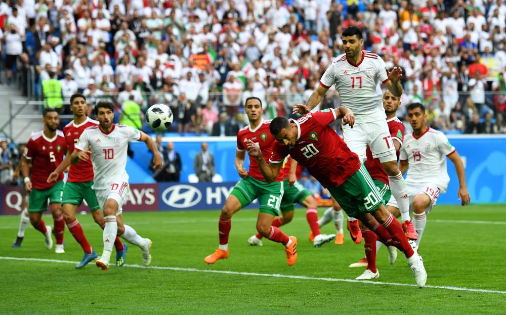 Soccer Football - World Cup - Group B - Morocco vs Iran - Saint Petersburg Stadium, Saint Petersburg, Russia - June 15, 2018   Morocco's Aziz Bouhaddouz scores an own goal for Iran's first goal   REUTERS/Dylan Martinez     TPX IMAGES OF THE DAY