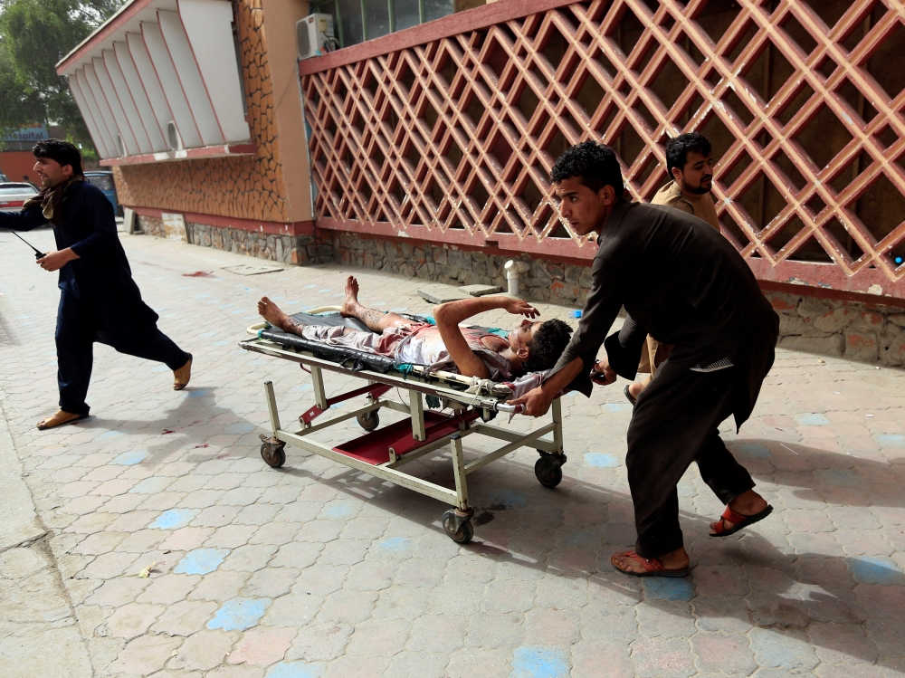 ATTENTION EDITORS - VISUAL COVERAGE OF SCENES OF INJURY OR DEATH ??An injured man is pushed on a stretcher to a hospital after a car bomb in Jalalabad city, Afghanistan June 17, 2018. REUTERS/Parwiz