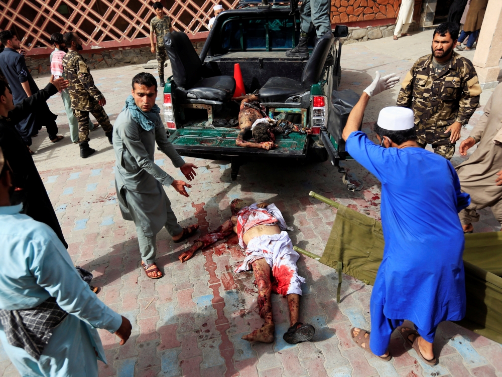 ATTENTION EDITORS - VISUAL COVERAGE OF SCENES OF INJURY OR DEATH ??People prepare to carry an injured man to a hospital after a car bomb in Jalalabad city, Afghanistan June 17, 2018. REUTERS/Parwiz ??TEMPLATE OUT