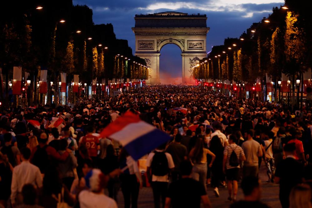 Soccer Football - World Cup - Semi-Final - France vs Belgium - Paris, France, July 10, 2018 - France fans react on the Champs-Elysees after defeating Belgium in their World Cup semi-final match. REUTERS/Charles Platiau