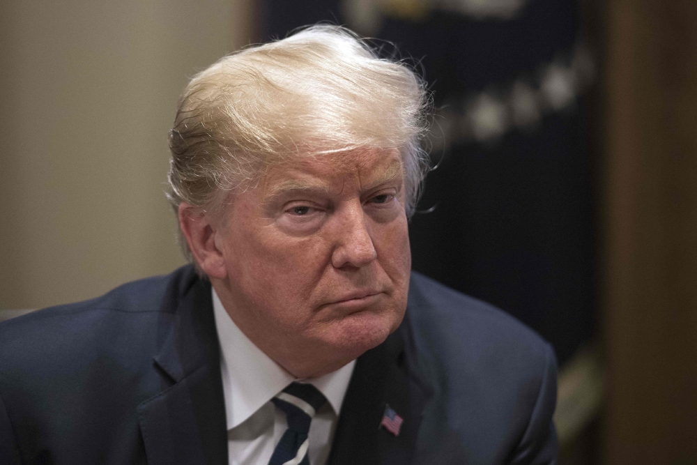 TOPSHOT - US President Donald Trump speaks about his meeting with Russian President Vladimir Putin ahead of a meeting with Republican lawmakers and cabinet members on tax cuts at the White House in Washington, DC, on July 17, 2018. / AFP / NICHOLAS KAMM
