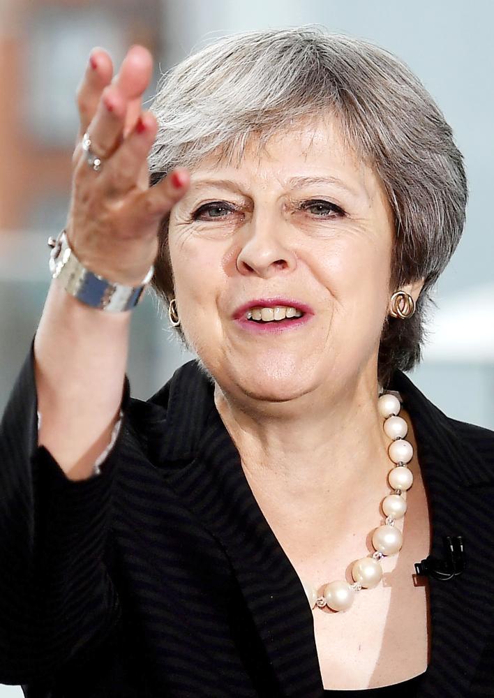 Britain's Prime Minister Theresa May gestures as she delivers a keynote speech on Brexit at Waterfront Hall in Belfast, Northern Ireland, on July 20, 2018. With a trip to Northern Ireland this week, May began a tour of Britain to convince voters to back her blueprint for close economic ties with the bloc after Brexit next March. / AFP / POOL / Charles McQuillan
