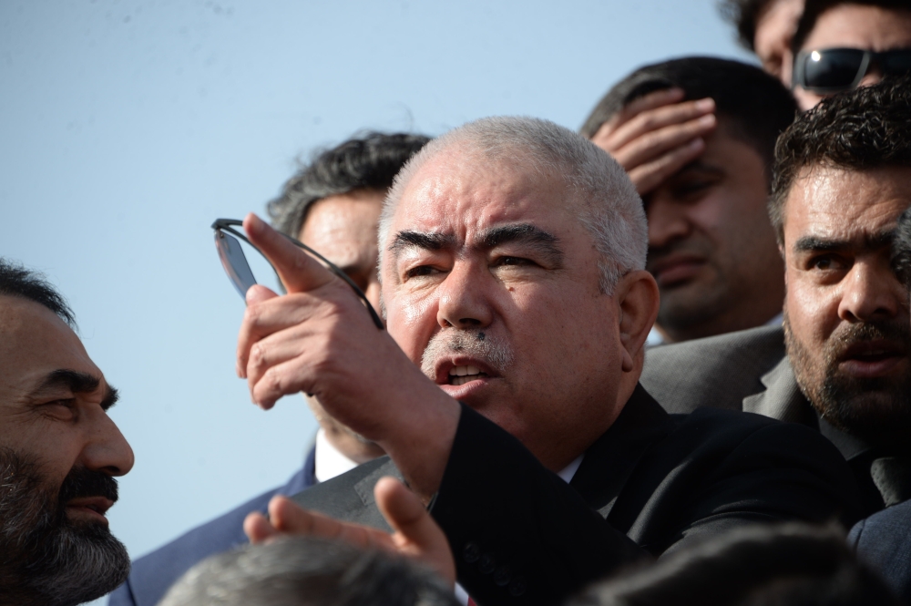 In this photo taken on July 22, 2018, Afghan Vice President Abdul Rashid Dostum (C) arrives at Hamid Karzai International Airport in Kabul. The death toll from a suicide attack near Kabul international airport has risen to 23, the health ministry said July 23, with an AFP driver among the dead. At least 107 others were wounded in the powerful explosion on July 22, which happened as scores of people were leaving the airport after welcoming home Afghan Vice President Abdul Rashid Dostum from exile.

 / AFP / NOORULLAH SHIRZADA
