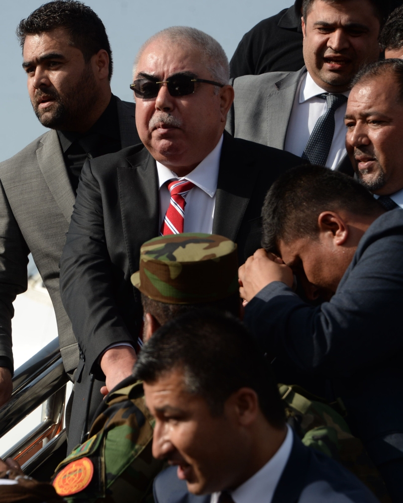 In this photo taken on July 22, 2018, Afghan Vice President Abdul Rashid Dostum (C) arrives at Hamid Karzai International Airport in Kabul. The death toll from a suicide attack near Kabul international airport has risen to 23, the health ministry said July 23, with an AFP driver among the dead. At least 107 others were wounded in the powerful explosion on July 22, which happened as scores of people were leaving the airport after welcoming home Afghan Vice President Abdul Rashid Dostum from exile.

 / AFP / NOORULLAH SHIRZADA
