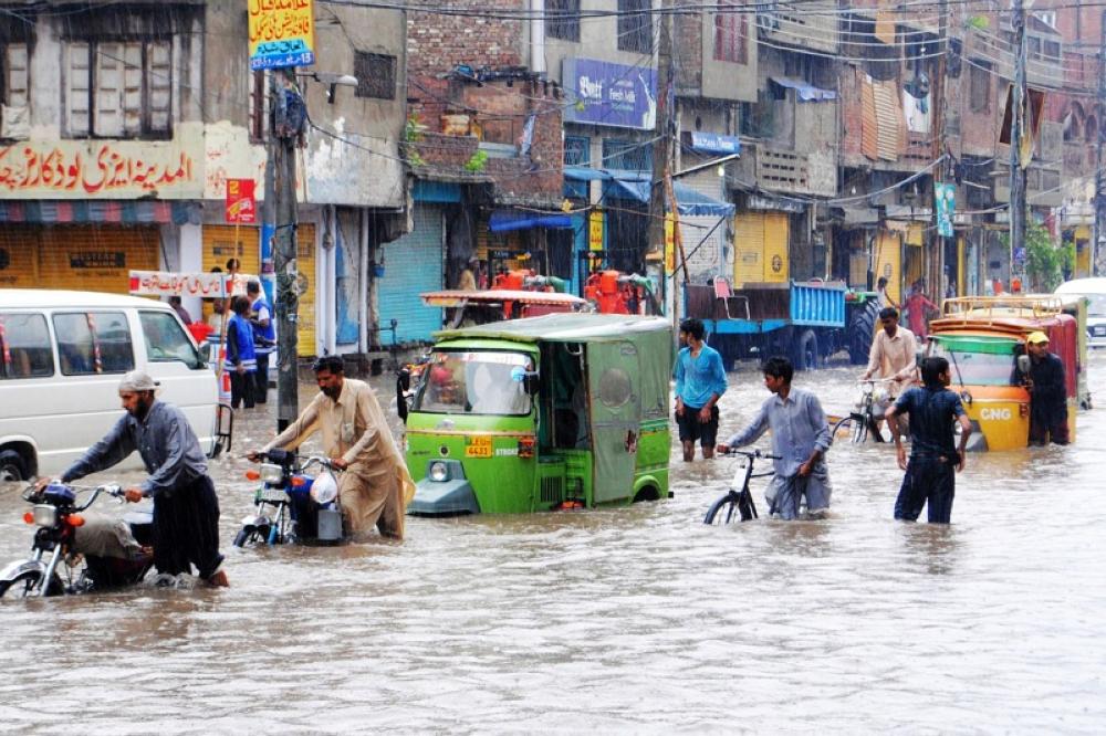 LAHORE, July 4, 2011  People walk in waterlogged streets after heavy monsoon rain in eastern Pakistan's Lahore on July 4, 2011. About 20 people were killed due to monsoon rains in different parts of the country(Credit Any Usage: ©ZUMAPRESS.com/Keystone Press)