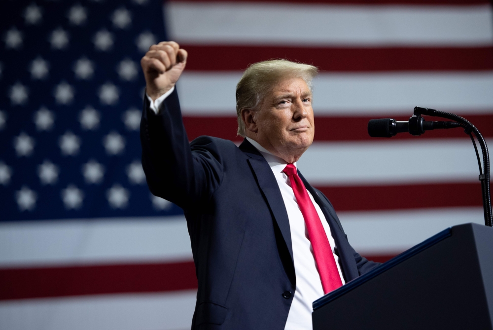 (FILES) In this file photo taken on July 31, 2018 US President Donald Trump speaks during a campaign rally at the Florida State Fairgrounds Expo Hall in Tampa, Florida. US President Donald Trump is now considering a 25 percent tariff on $200 billion in Chinese imports, rather than the 10 percent previously touted, reports said July 31, 2018. The US imposed tariffs of 25 percent on $34 billion of Chinese products earlier this month, with plans to add another $16 billion of imports on Tuesday.
 / AFP / SAUL LOEB
