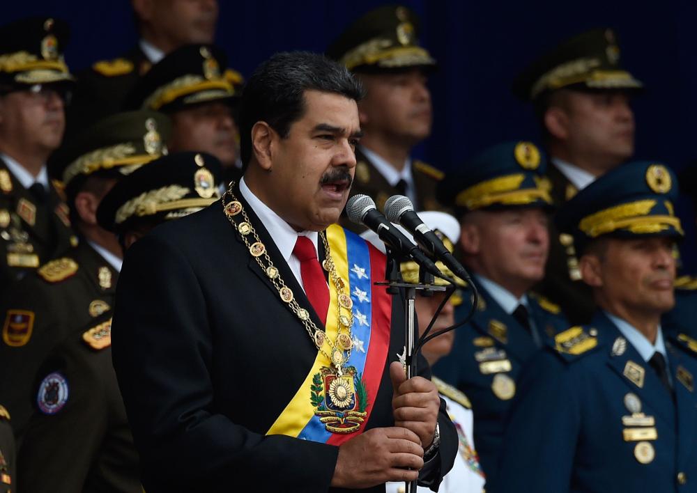 Venezuelan President Nicolas Maduro delivers a speech during a ceremony in support of the National Guard in Caracas on August 4, 2018 day in which Venezuela's controversial Constituent Assembly marks its first anniversary. The Constituent Assembly marks its first anniversary on August 4 as the embodiment of Maduro's entrenchment in power despite an economic crisis that has crippled the country's public services and destroyed its currency. The assembly's very creation last year was largely responsible for four months of street protests that left some 125 people dead.
 / AFP / Juan BARRETO
