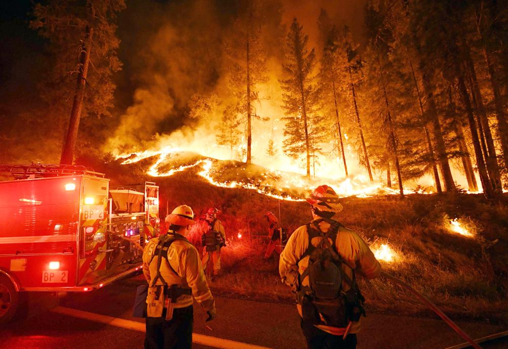 (FILES) In this file photo taken on July 31, 2018 firefighters try to control a back burn as the Carr fire continues to spread towards the towns of Douglas City and Lewiston near Redding, California. The toll from the California wildfires rose to 10 on August 9, 2018 after a heavy equipment mechanic assigned to the Carr Fire was killed in a road accident, authorities said.The Carr Fire, near the city of Redding, has proved to be the deadliest of nearly 20 major fires raging across the state, having previously claimed seven lives, including two firefighters.
/ AFP / Mark RALSTON 