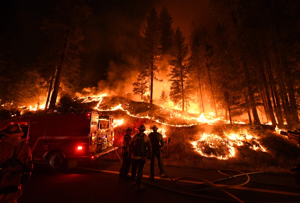 (FILES) In this file photo taken on July 31, 2018 firefighters try to control a back burn as the Carr fire continues to spread towards the towns of Douglas City and Lewiston near Redding, California. The toll from the California wildfires rose to 10 on August 9, 2018 after a heavy equipment mechanic assigned to the Carr Fire was killed in a road accident, authorities said.The Carr Fire, near the city of Redding, has proved to be the deadliest of nearly 20 major fires raging across the state, having previously claimed seven lives, including two firefighters.
/ AFP / Mark RALSTON 