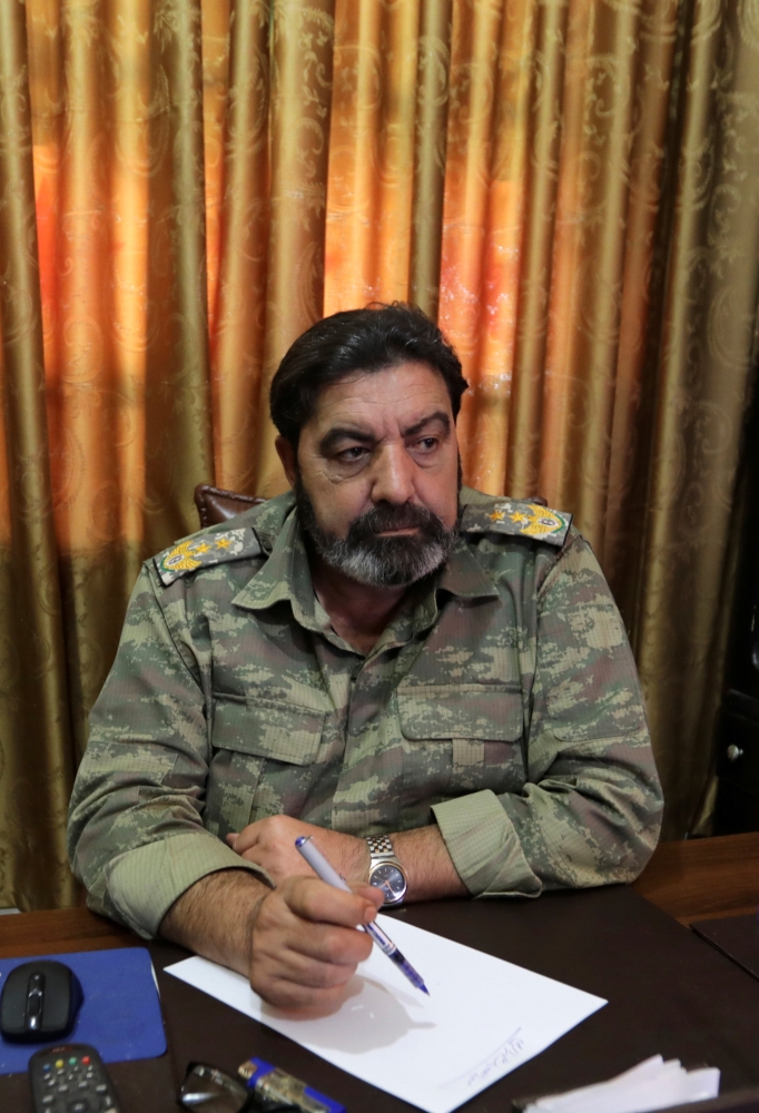 Colonel Haitham Afisi talks during an interview with Reuters at his office in the town of Azaz, Syria August 6, 2018. Picture taken August 6, 2018. REUTERS/ Khalil Ashawi